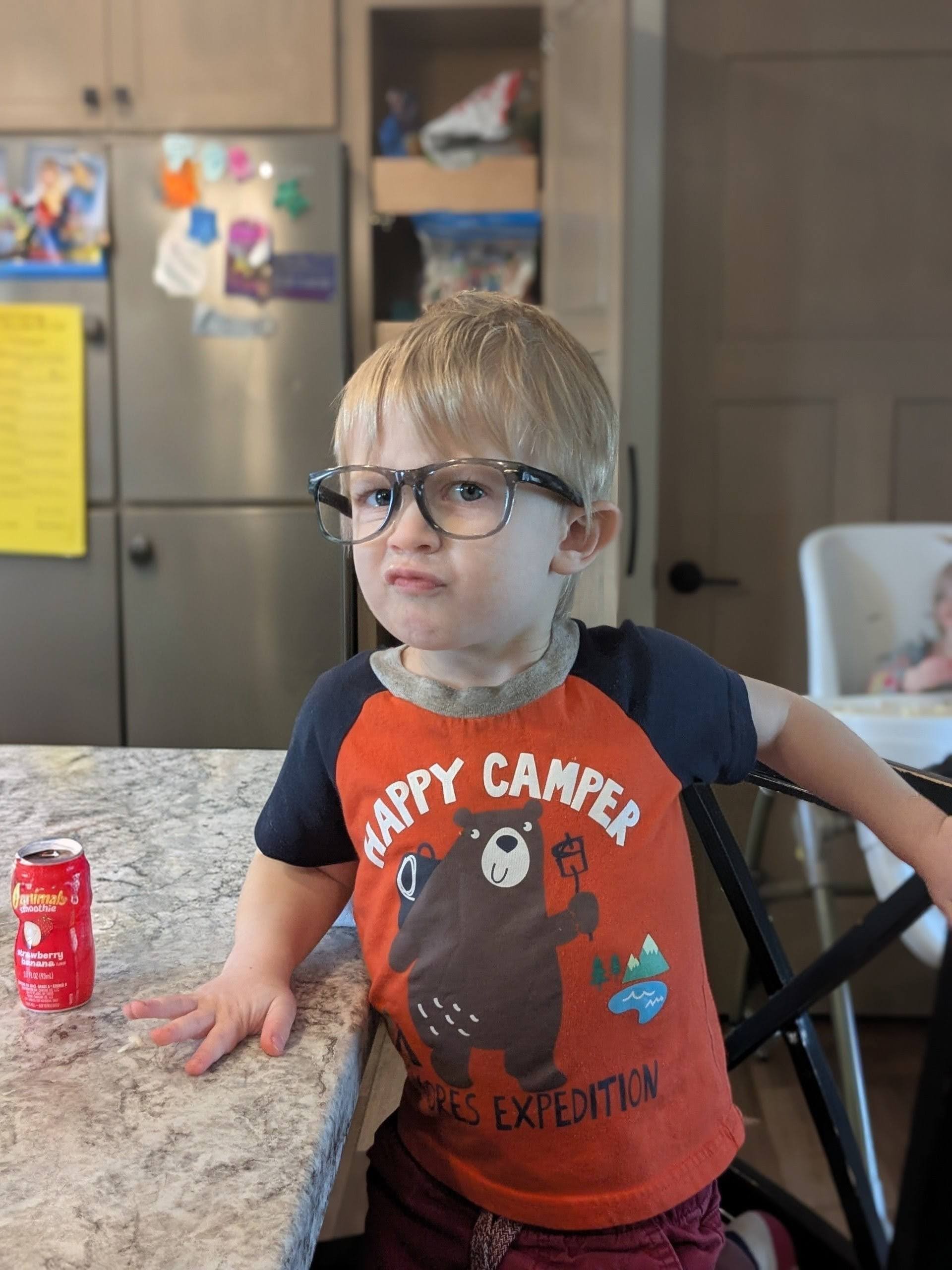 Oscar wearing glasses in the kitchen